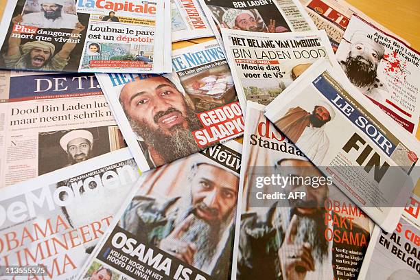 Illustration photo taken on May 3, 2011 in Brussels shows several Belgian newspapers' front pages, reporting on the death of Al Qaeda leader Osama...