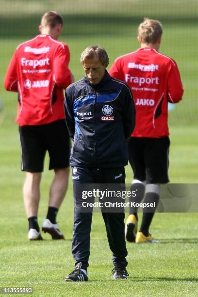 Head coach Christoph Daum of Frankfurt ponders during the training session on the training ground at the Commerzbank Arena on May 3, 2011 in...