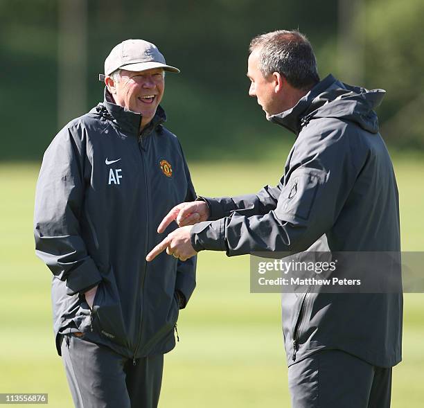 Sir Alex Ferguson of Manchester United shares a joke with coach Rene Meulensteen ahead of their UEFA Champions League Semi-Final second leg against...