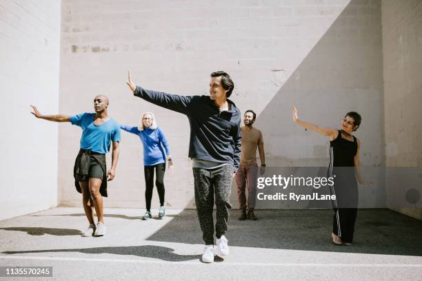diverse outdoor multigenerational dance class group - dance troupe stock pictures, royalty-free photos & images