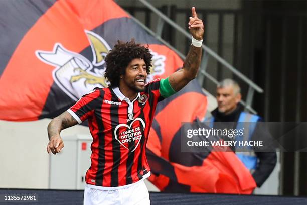 Nice's Brazilian defender Dante gestures as he celebrates after scoring a goal during the French L1 football match between Nice and Montpellier on...