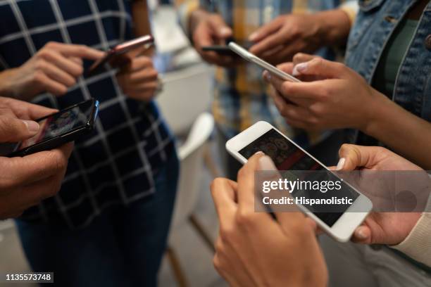 group of people betting online using their smartphones - internet gambling stock pictures, royalty-free photos & images