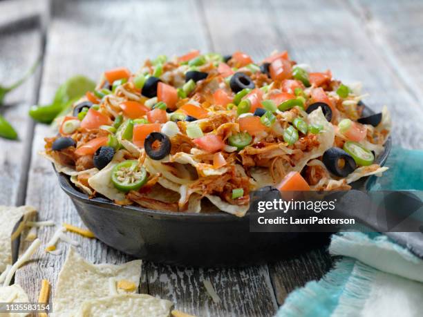 loaded bbq pulled jack fruit nachos - black olive stock pictures, royalty-free photos & images