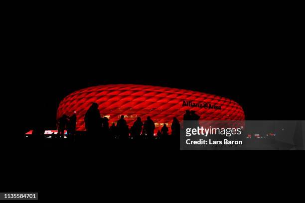 Fans walk outside the stadium prior to the UEFA Champions League Round of 16 Second Leg match between FC Bayern Muenchen and Liverpool at Allianz...