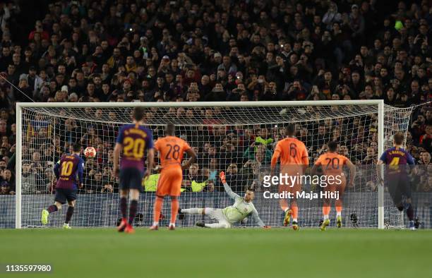 Lionel Messi of Barcelona scores his team's first goal from a penalty past Anthony Lopes of Olympique Lyonnais during the UEFA Champions League Round...