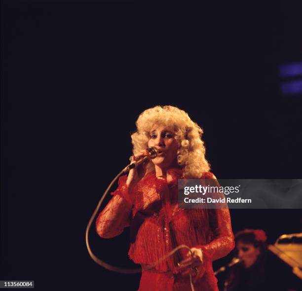 Tammy Wynette , U.S. Country music singer-songwriter, singing into a microphone during a live concert performance at the International Festival of...