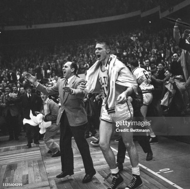 Tom Heinsohn and Red Auerbach celebrate the Celtics victory.