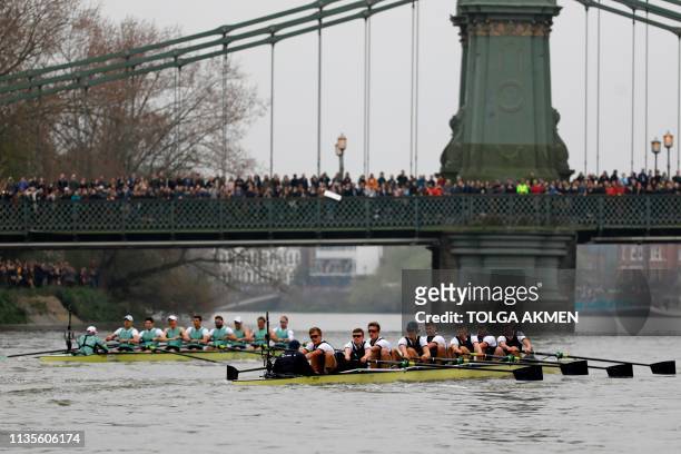 The Oxford boat trails the Cambridge boat towards Hammersmith Bridge during the 165th annual men's boat race between Oxford University and Cambridge...