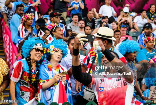 Kameli Raravou Soejima of Japan takes a selfie with fans on day three of the Cathay Pacific/HSBC Hong Kong Sevens at the Hong Kong Stadium on April...
