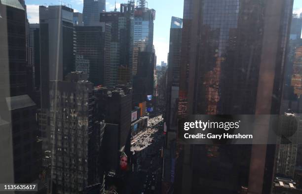 Sunlight illuminates Times Square nestled between buildings along Broadway and 7th Avenue on March 12, 2019 in New York City.