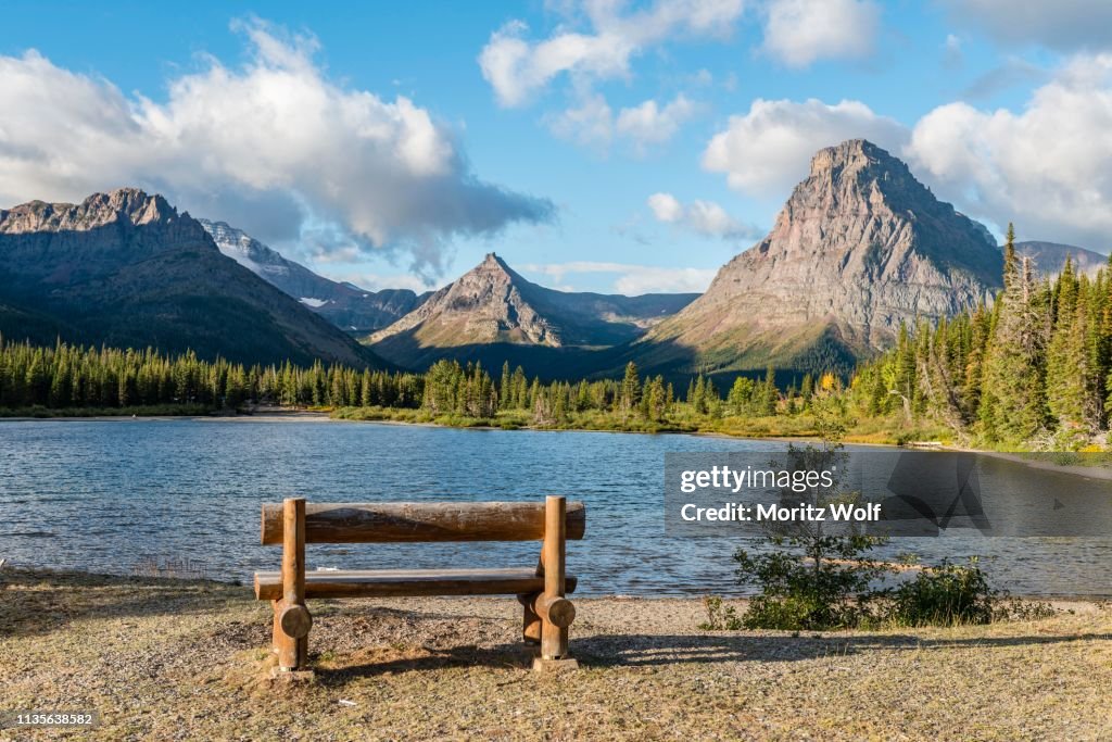 Viewing bench at the mountain lake, Two Medicine Lake, mountain landscape, Sinopah Mountain, Glacier National Park, Montana, USA