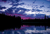 A Canadian sunset turns the clouds pink in northern Saskatchewan