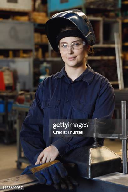 young australian female trainee welder - welding helmet stock pictures, royalty-free photos & images