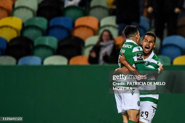 Sporting's Brazilian forward Luiz Phellype celebrates his goal with teammate Sporting's Argentinian forward Marcos Acuna during the Portuguese league...