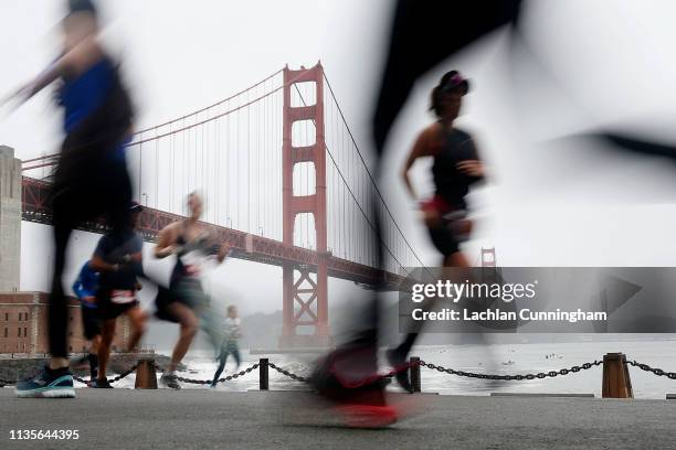 The Golden Gate Bridge is seen as runners race along the waterfront during the United Airlines Rock 'N' Roll Half Marathon San Francisco on April 7,...