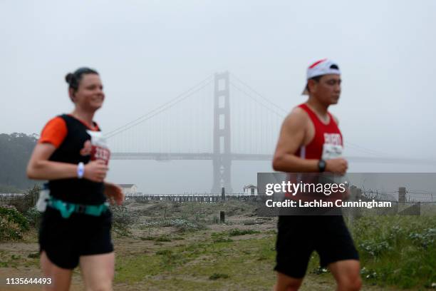 The Golden Gate Bridge is seen in the background as runners take part in the United Airlines Rock 'N' Roll Half Marathon San Francisco on April 7,...