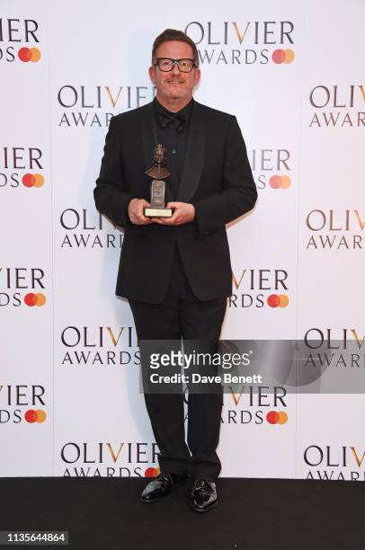 Sir Matthew Bourne, winner of the Special Award, poses in the press room at The Olivier Awards 2019 with Mastercard at The Royal Albert Hall on April...