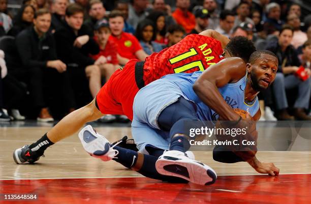 Miles of the Memphis Grizzlies dives for a loose ball against Jaylen Adams of the Atlanta Hawks in the second half at State Farm Arena on March 13,...