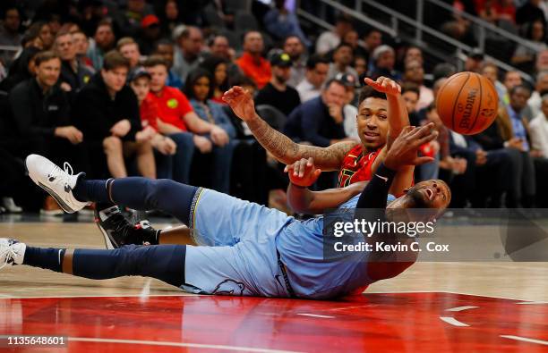 Miles of the Memphis Grizzlies makes a pass from his back after diving for a loose ball against Jaylen Adams of the Atlanta Hawks in the second half...