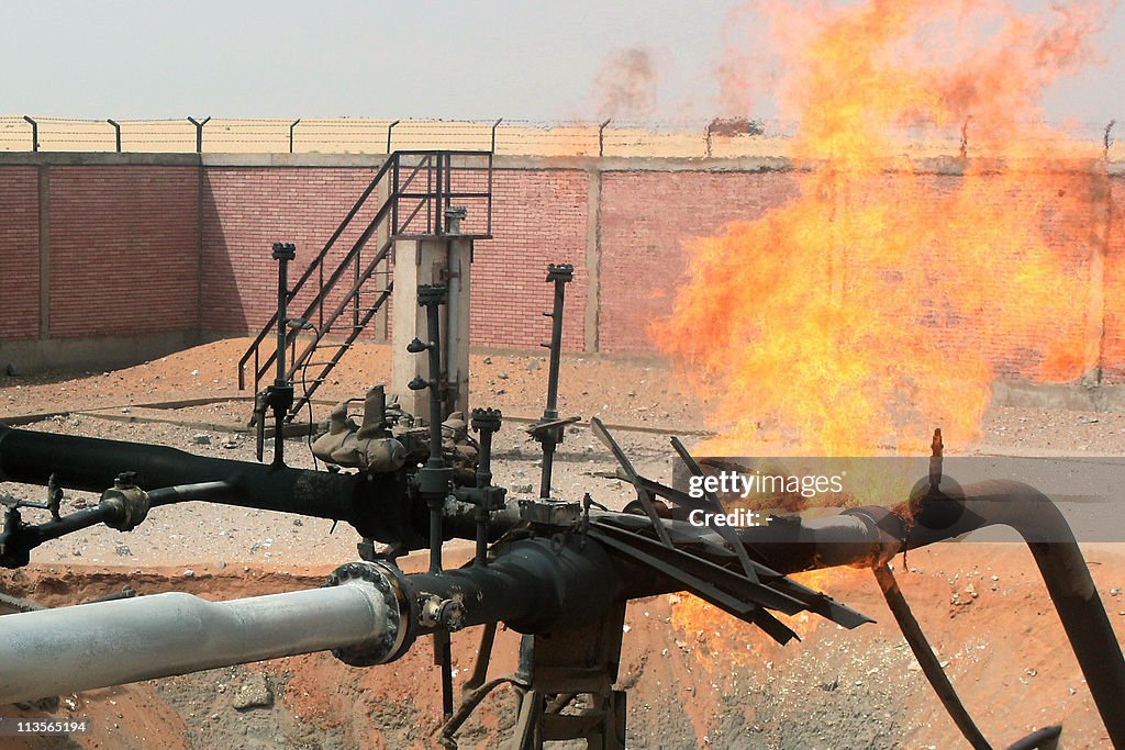 Flames shoot into the sky from a gas pip