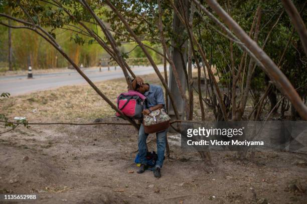 Venezuelan migrant rests while walking to the city of Boa Vista in search of work and better conditions on April 7, 2019 in Pacaraima, Brazil....