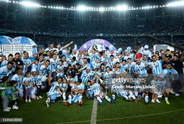 Players of Racing Club pose with the trophy to celebrate the championship after a match between Racing Club and Defensa y Justicia as part of...