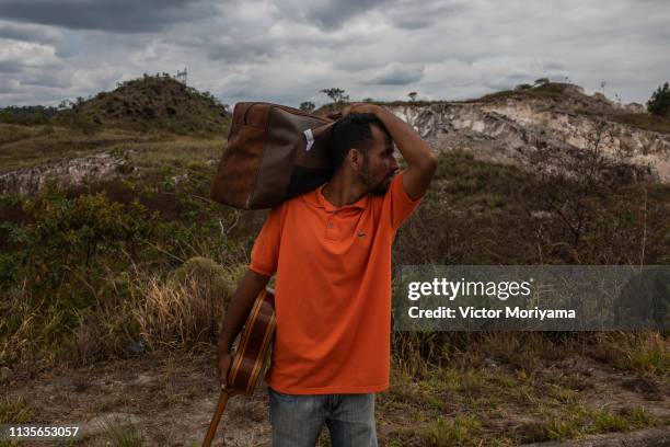 Member of a family of Venezuelan musicians walks to the city of Boa Vista in search of work and better conditions on April 7, 2019 in Pacaraima,...