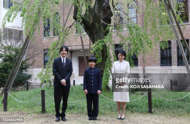 Japan's Prince Hisahito , accompanied by his parents Prince Akishino and Princess Kiko , poses for photos at Ochanomizu University junior high school...
