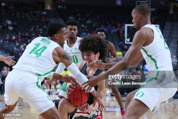 Elleby of the Washington State Cougars battles for the ball against Kenny Wooten of the Oregon Ducks during a first-round game of the Pac-12...