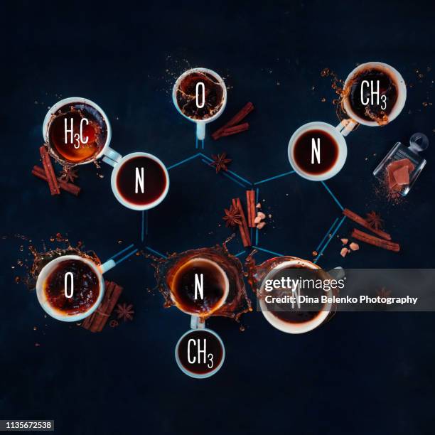 caffeine molecule made with coffee cups. creative coffee flat lay. science of coffee concept - caffeine molecule stockfoto's en -beelden