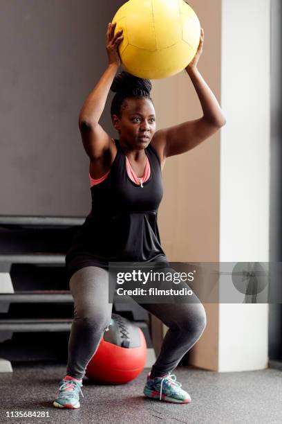 curvy woman in the gym - medicine ball stock pictures, royalty-free photos & images