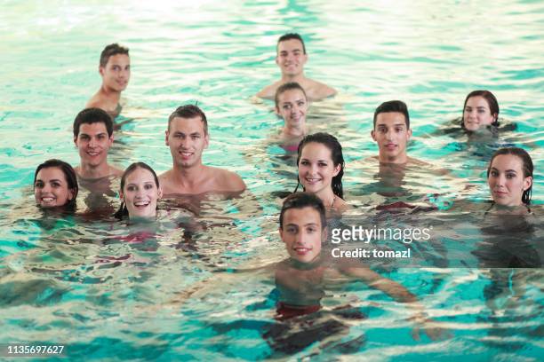 female friends having fun in the pool - portrait photo - organised group photo stock pictures, royalty-free photos & images