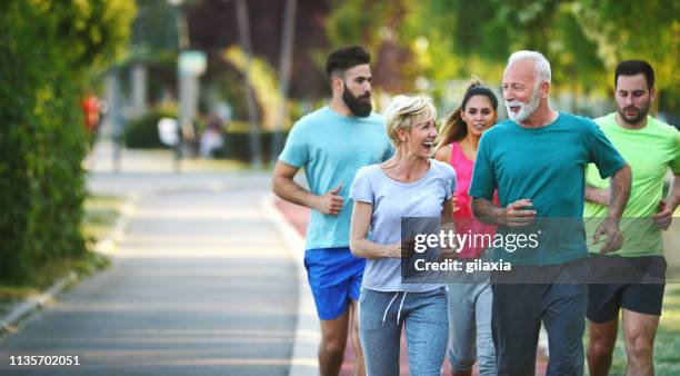 afternoon with family and friends - group of people running stock pictures, royalty-free photos & images