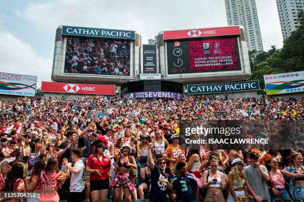 This picture taken on April 7 shows fans attending the third day of the Hong Kong Sevens rugby tournament. - The Hong Kong Sevens will soon bid...