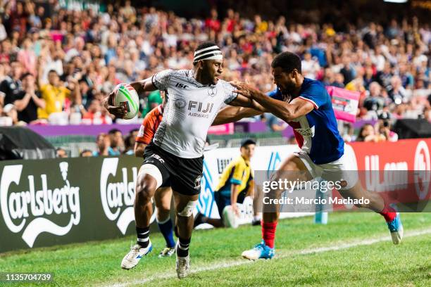 Remi Siega of France puts a tackle on Vilimoni Derenalagi of Fiji during the day three of the Cathay Pacific/HSBC Hong Kong Sevens Cup Final match...