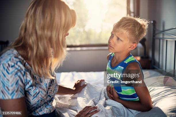 mother taking care of little boy with a stomach ache - dor de barriga imagens e fotografias de stock