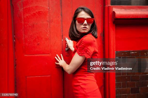 beautiful woman in red - shhh finger stock pictures, royalty-free photos & images