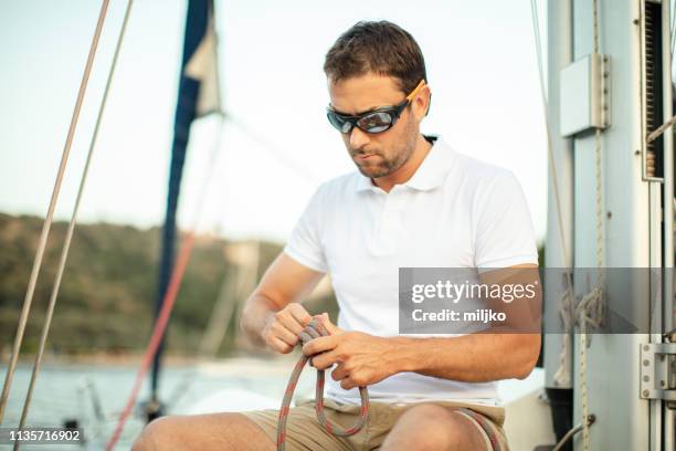 skipper of the sailboat - shade sail stock pictures, royalty-free photos & images