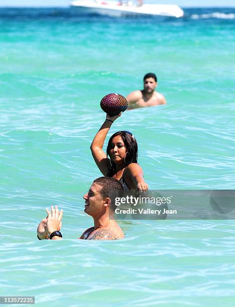 Television personalities Vinny Guadagnino and Nicole "Snooki" Polizzi visit the beach on May 20, 2010 in Miami Beach, Florida.