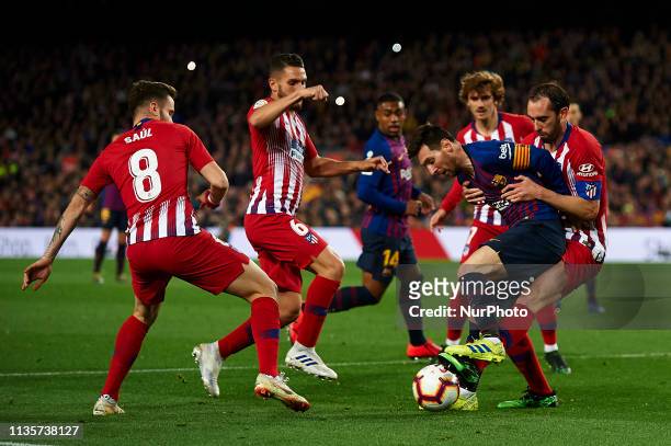 Lionel Messi of Barcelona controls the ball surrounded by Atletico players during the La Liga match between FC Barcelona and Club Atletico de Madrid...