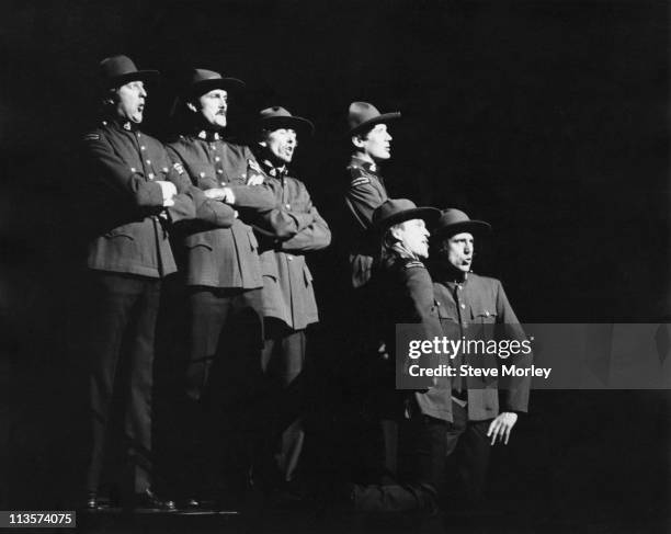 Graham Chapman , John Cleese, George Harrison , Michael Palin, Terry Gilliam and Terry Jones performing 'The Lumberjack Song' on stage at the City...