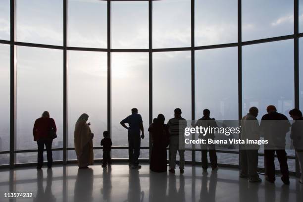 people watching dubai from burj khalifa - burj khalifa stock-fotos und bilder