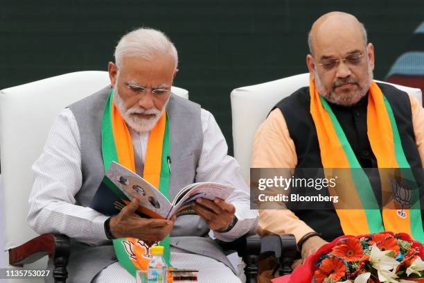 Narendra Modi, India's prime minister, left, and Amit Shah, president of the Bharatiya Janata Party, attend an event marking the release of the BJP...