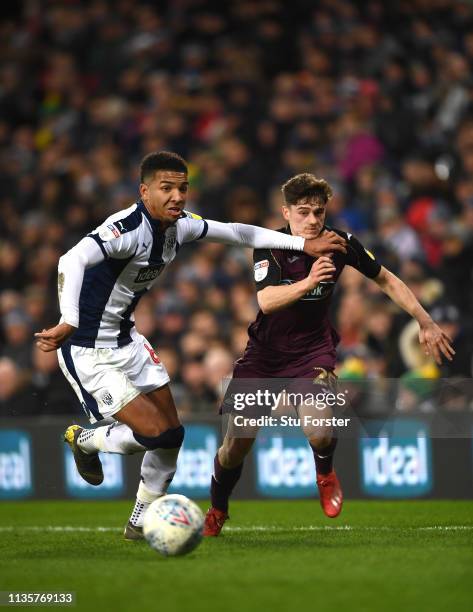 Swansea player Daniel James is held off the ball by WBA player Mason Holgate during the Sky Bet Championship match between West Bromwich Albion and...