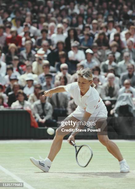 Martina Navratilova of the United States makes a low forehand return to Chris Evert-Lloyd during their Women's Singles Final match at the Wimbledon...