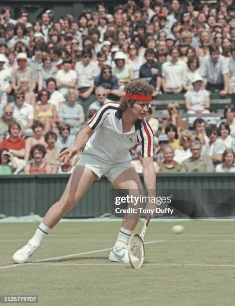 John McEnroe of the United States makes a low forehand return against Buster Mottram during their Men's Singles second round match at the Wimbledon...