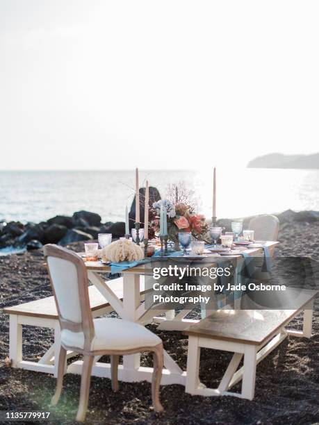 table setting on a beach in santorini for an outdoor beach wedding - wedding table setting bildbanksfoton och bilder