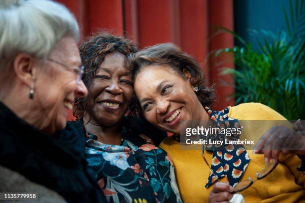women having fun on a sofa - senior women group stock pictures, royalty-free photos & images