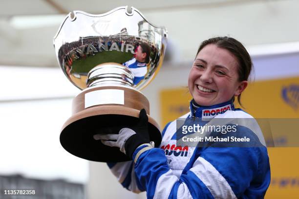 Jockey Bryony Frost poses with the trophy after she rides Frodon to victory during the Ryanair Chase race during St Patrick's Thursday at Cheltenham...