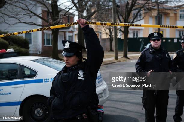 Police stand along the street where reputed mob boss Francesco “Franky Boy” Cali lived and was gunned down on March 14, 2019 in the Todt Hill...